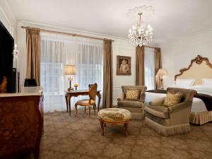 a large hotel room with a bed and a desk at The Plaza in New York