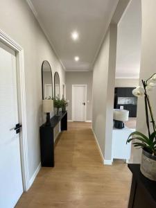 a hallway of a home with a room with a mirror at Appartement au cœur de Nice avec climatisation in Nice