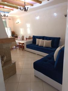 a living room with two blue couches in a room at Quartier riad résidence riad in Ifrane