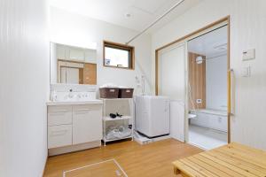 bagno bianco con lavandino e frigorifero di 24 ORIYA Mt Fuji -鳴沢 NARUSAWA- a Narusawa