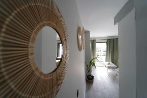 a mirror on a wall in a living room at Tropical Views - Paya del Inglés in Maspalomas