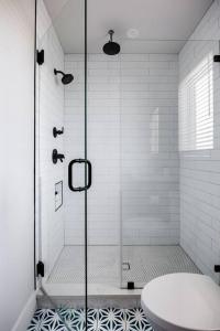 a shower with a glass door in a bathroom at 5 Min to UT, Congress - Modern Home in DT East ATX in Austin