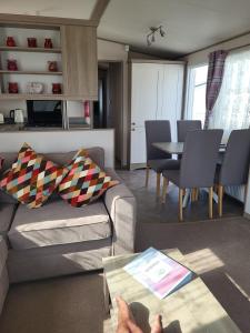 a living room with a couch and a table at Your Retreat Too in Camber