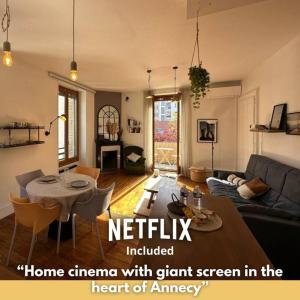 a living room with a couch and a table at Duplex loft - Central avec home cinéma in Annecy