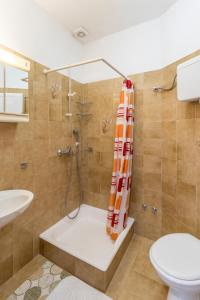 a bathroom with a shower and a toilet at Apartments with parking space Baska Voda, Makarska - 301 in Baška Voda +39 photos
