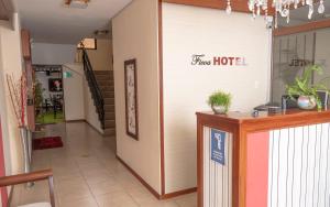 a hotel lobby with a guest hotel sign on the wall at Hotel Ficoa in Ambato