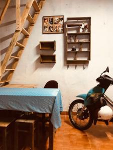 a motorcycle parked in a room with a table at RosiesHome in Da Lat