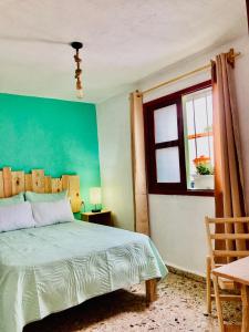 a bedroom with a bed and a window at Alhambra Hotel - San Cristóbal de las Casas in San Cristóbal de Las Casas