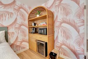 a room with a book shelf with a microwave in it at Santa Monica Hotel in Los Angeles