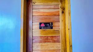 a wooden door with a sign on it at Villa Lorenzo @ Caliraya Heights Resorts in Halang