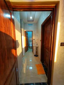 a hallway of a bathroom with a toilet and a sink at Residence Anarouz - Sidi Ifni in Sidi Ifni