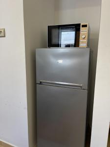 a microwave sitting on top of a refrigerator at Surfside Studio in Taghazout 2-3px in Taghazout