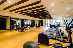 a gym with treadmills and ellipticals in a building at Monarch Parksuites - Balmoral Place (near NAIA, MOA, MOA Arena, DFA) in Manila