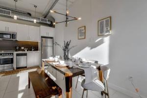 a kitchen with a wooden table and chairs in it at Luxury downtown loft 1 bedroom in Los Angeles