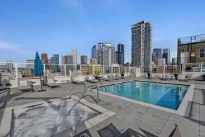 a swimming pool on top of a building with a city skyline at Luxury downtown loft 1 bedroom in Los Angeles