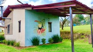 a building with a painting of a bird on it at Cabañas Huerta la Mision, Zacatlán in Zacatlán
