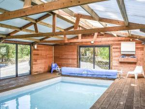 a swimming pool in a house with a wooden ceiling at The Old Chapel in Washaway