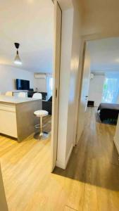 a living room with a bed and a table in a room at Aux vents des rhums au cœur de la Marina du Gosier avec vue imprenable in Pointe-à-Pitre