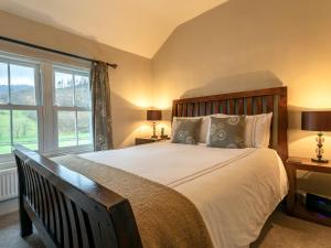 a bedroom with a large bed and a window at Catstycam in Thirlmere