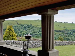 a view from a porch with a stone wall at Broadmeadows Farm in Butterton