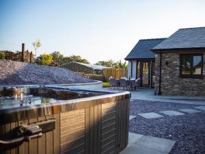 a backyard with a stone house with a sink at Stabl in Cross Inn