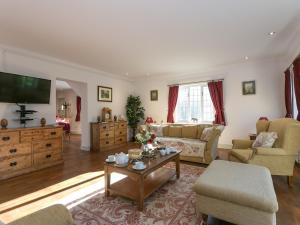 a living room with a couch and a table at Twisly North Lodge in Catsfield