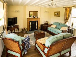 a living room with a couch and a tv at Greenah View in Uldale