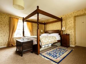 a bedroom with a canopy bed and a window at Greenah View in Uldale