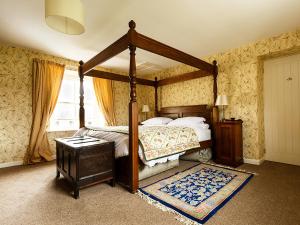 um quarto com uma cama de dossel e uma janela em Greenah View em Uldale
