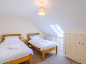 two twin beds in a room with a window at Dawson Park 4 - Uk12663 in Mablethorpe