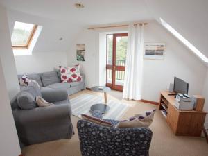 a living room with a couch and a tv at Uk13326 Pines in Rosemarkie