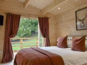 a bedroom with a bed and a large window at Brook Cottage - Uk12643 in Sleights