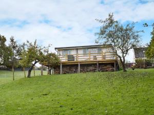 a house sitting on top of a green field at Brook Cottage - Uk12643 in Sleights