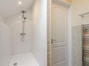 a white shower with a glass door in a bathroom at Dutch Barn Two - Uk12873 in Brynkir