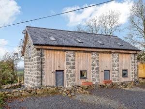 an old stone building with a slate roof at Dutch Barn Two - Uk12873 in Brynkir