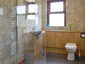 a bathroom with a toilet and a sink and a shower at East Lodge in Kingholm Quay