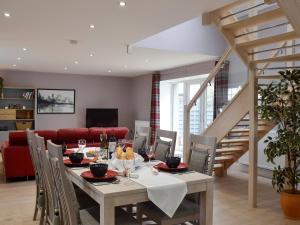 a dining room with a table and chairs at Torcross Barn in Tarbolton