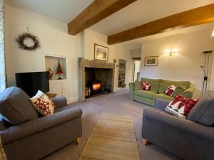 a living room with two couches and a fireplace at Ivy Cottage in Grassington