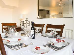 a dining room table with white plates and wine glasses at What A View! in Whitby