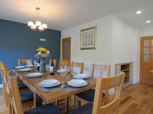 a dining room with a wooden table and chairs at Bryn Derw in Barmouth