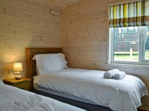 a bedroom with two beds and a window at Bransty in Keswick