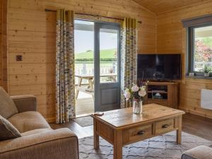 a living room with a couch and a coffee table at Birch Lodge - Uk30006 in Lindal in Furness