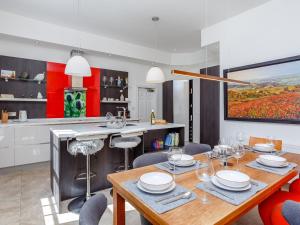 a kitchen with a wooden table and a dining room at Skene House Court in Dunecht