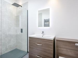 a bathroom with a sink and a shower at Marshall Cottage in Santon