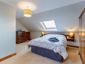 a bedroom with a bed and a skylight at Cairn-o-mhor in Lendalfoot
