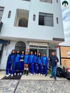 a group of people standing in front of a building at Hospedaje El Encanto del Bosque in Ica