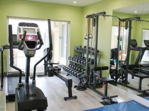 a gym with several tread machines and a mirror at The Steading in Glencripesdale