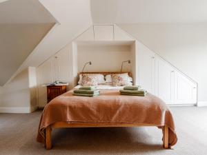 a bedroom with a bed with pillows on it at Mill View in Aberfeldy