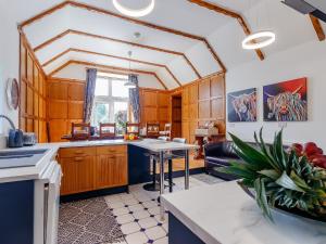 a kitchen with wooden cabinets and a table in a room at Torreagles in Mintlaw