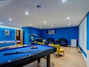 a pool table in a living room with blue walls at Torreagles in Mintlaw